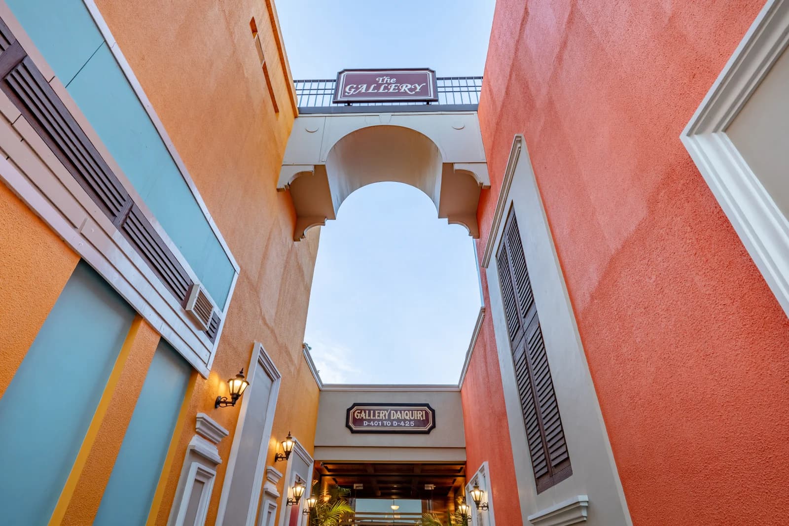 Mediterranean style painted archway and lantern entrance between resort wings