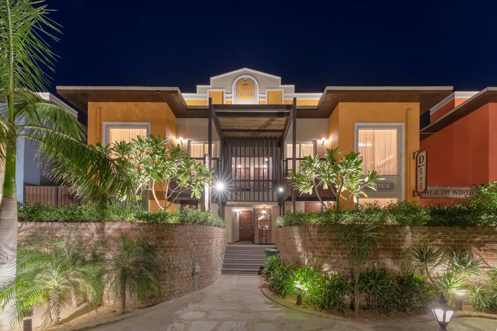 Night illumination of Villa Bellini luxury suite villas with brick garden walkway