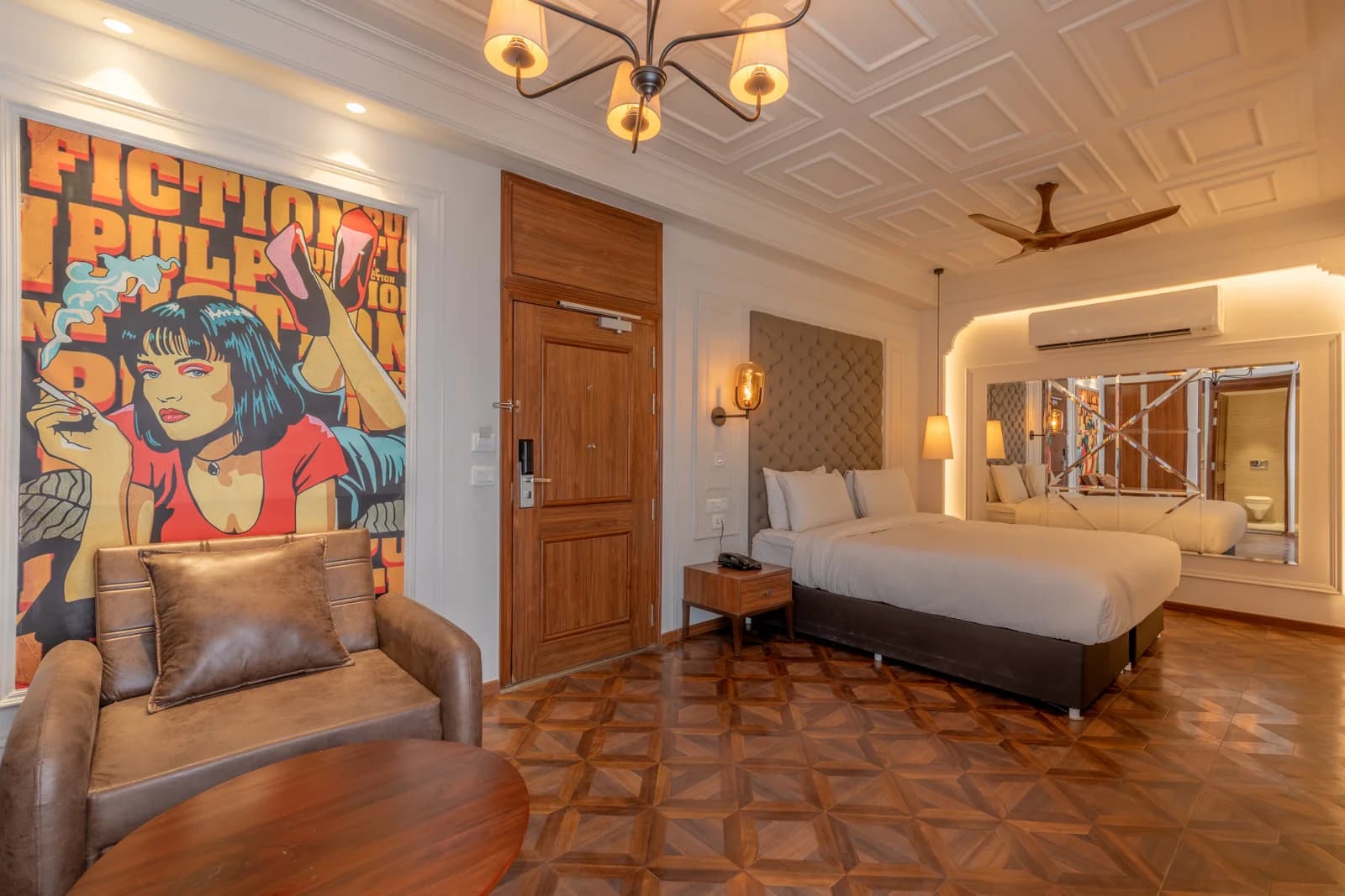 Themed luxury suite bedroom with pop-art mural, parquet floor, and tufted headboard