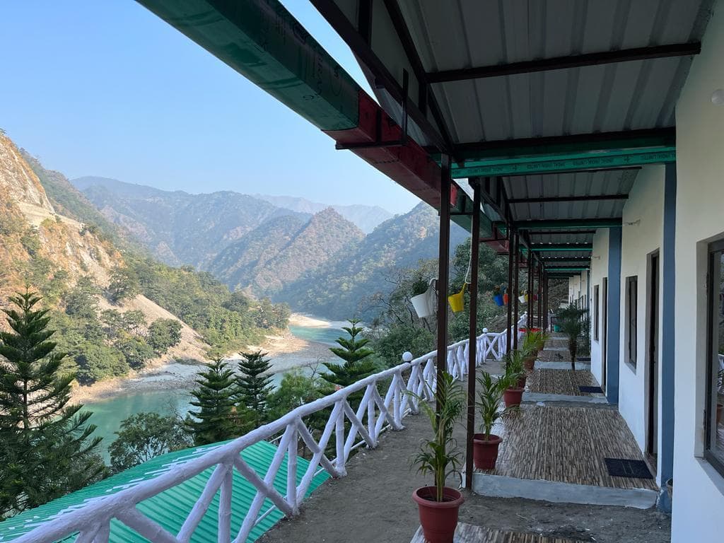 Daytime perspective of cottage veranda looking toward Ganga river and mountains