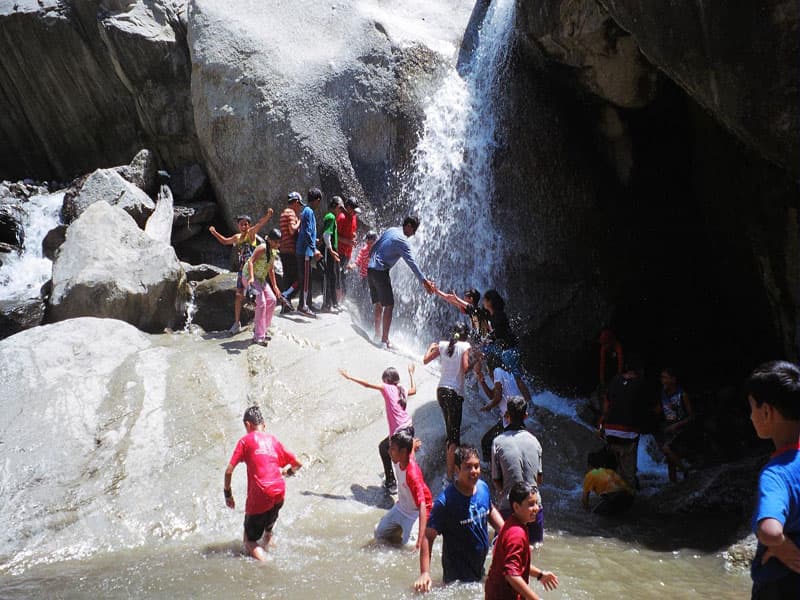 Guided excursion group visiting the base of Tiger Falls near Chakrata
