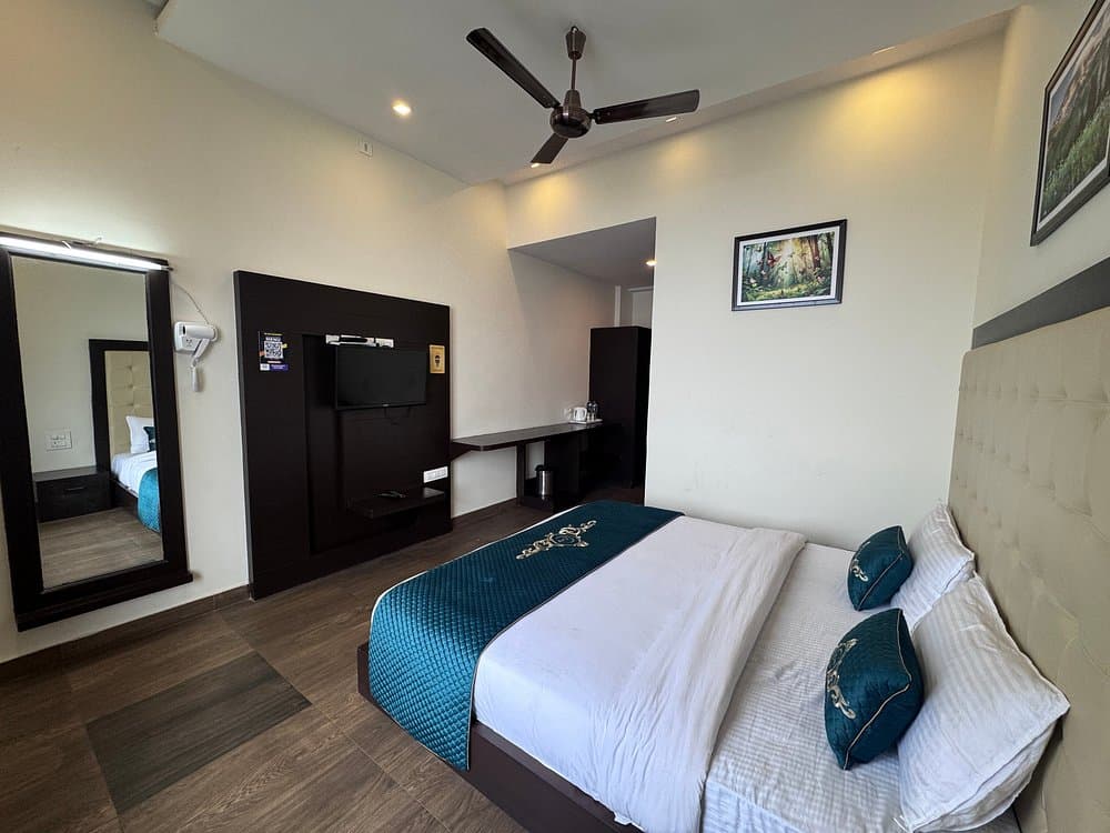 Deluxe guest bedroom with wooden panelling and double bed at Cozypine Kanatal