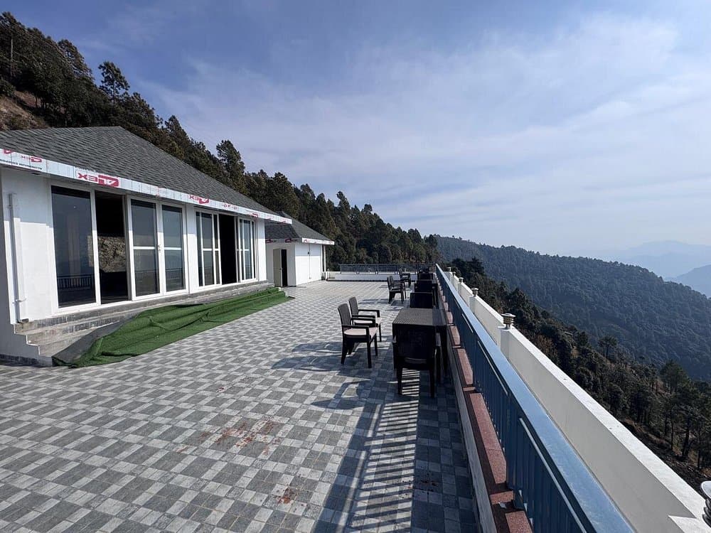 Panoramic mountain clouds and cedar ridge views from the terrace of Cozypine Kanatal